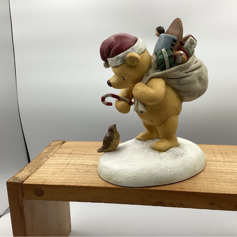 Winnie the Pooh Santa figurine.
